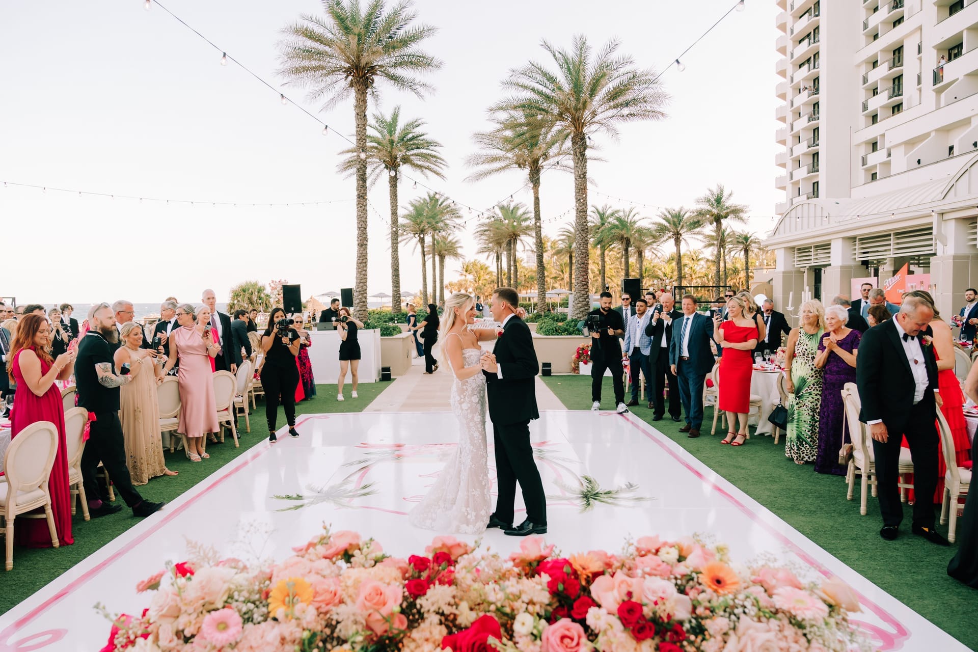 A long head table covered in candlelight and roses